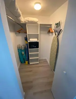 a room with a closet with a bed and shelves at 1 Bed & Kitchen at Beachwalk - Pool Gym Beach 22fl in Hallandale Beach