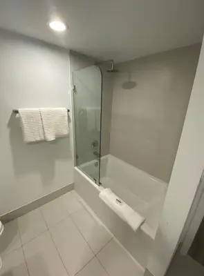 a bathroom with a shower with a glass door at 1 Bed & Kitchen at Beachwalk - Pool Gym Beach 22fl in Hallandale Beach