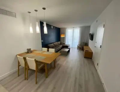 a living room with a table and a couch at 1 Bed & Kitchen at Beachwalk - Pool Gym Beach 22fl in Hallandale Beach