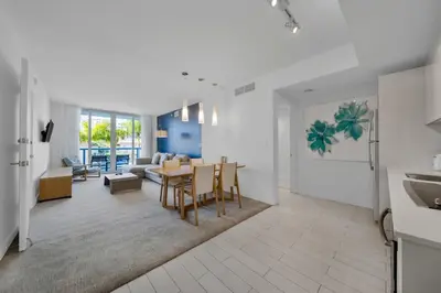 a kitchen and living room with a table and chairs at 2 Bed & 2 Bath at Beachwalk Pool Gym Beach on 19th in Hallandale Beach