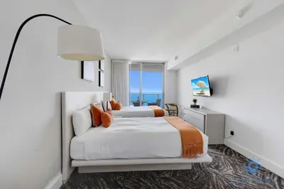 a bedroom with two beds and a large window at Cozy Apartment with Balcony in Hollywood