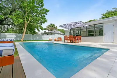 a swimming pool in the backyard of a house at Charming 4BR Oasis with Saltwater Pool and Parking in North Miami