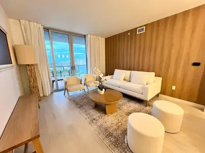 a living room with a couch and a table at Luxury Ocean Views Apt in Hallandale Beach in Hallandale Beach