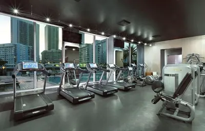 a gym with a bunch of treadms and machines at Luxury Ocean Views Apt in Hallandale Beach in Hallandale Beach