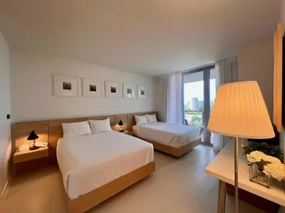 a hotel room with two beds and a window at Studio Luxury Ocean Views Apt in Hallandale Beach in Hallandale Beach