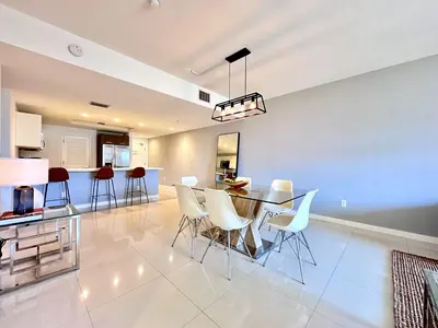 a dining room and kitchen with a table and chairs at Bay Breeze Premium Apartments by Eskape Collection in Miami Beach
