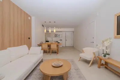 a living room with a white couch and a table at 2B 2B Luxury Ocean Views Apt in Hallandale Beach in Hallandale Beach