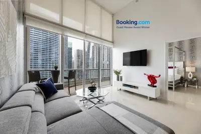 a living room with a couch and a tv at High Ceiling Exquisite 1BR 1BA ICON Brickell in Miami