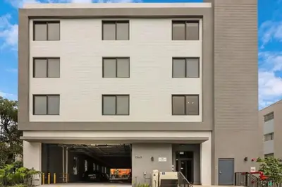 a large white building with a parking garage at Urban Oasis in Miami Close to Bayside and Brickell with Free Parking in Miami