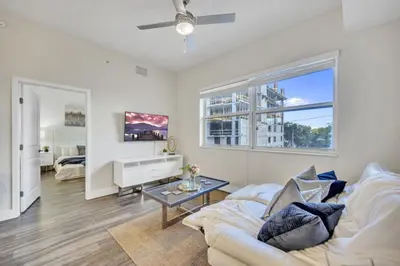 a living room with a white couch and a table at Trendy One Bedroom Getaway Steps from Biscayne in Miami