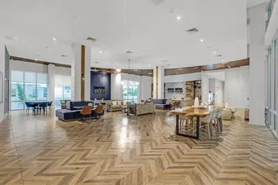 a large living room with wooden floors and furniture at Trendy One Bedroom Getaway Steps from Biscayne in Miami