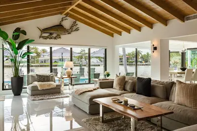 a living room with a couch and a table at Palm Pointe - One third of a mile to the beach - Heated Pool - Intracoastal Views in Fort Lauderdale