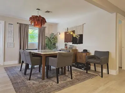 a dining room with a table and chairs at Casa Eden - Half mile to Lauderdale Marine Center - 4 bedrooms - 2 bathrooms in Fort Lauderdale