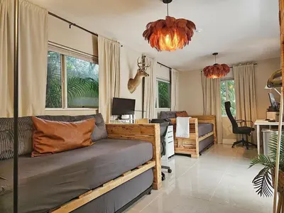a room with a bed and a desk with a computer at -Disco Bungalow- One third mile to FTL Marine Center in Fort Lauderdale