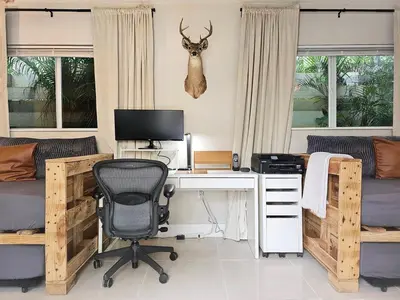 a bedroom with a desk with a computer and a deer head on the wall at -Disco Bungalow- One third mile to FTL Marine Center in Fort Lauderdale