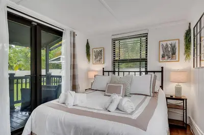 a white bedroom with a large bed with white pillows at Casa Del Sol Cozy 2br Retreat 10 Mins To Beach in Miami