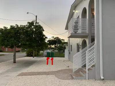 two red fire hydrants on a sidewalk next to a building at Stylish 2 Bedrooms Apartment by Miami Airport in Miami