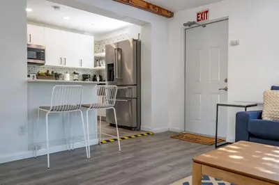 a kitchen with a refrigerator and two chairs and a table at Casa Fillmore - Hollywood Oasis in Hollywood