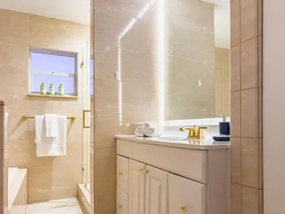 a bathroom with a sink and a mirror at Villa Tation 8BR Mini Hotel in Plantation