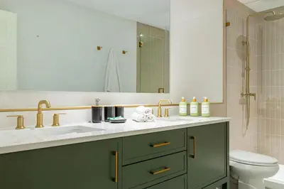 a bathroom with a sink and a toilet and a mirror at Villa Tation 8BR Mini Hotel in Plantation