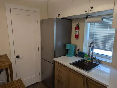 a kitchen with a sink and a refrigerator at Beach Breeze Suite - Steps to the Beach in Hollywood