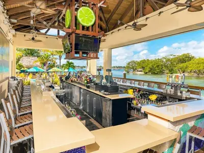 a restaurant with a bar with a view of the water at Beach Breeze Suite - Steps to the Beach in Hollywood