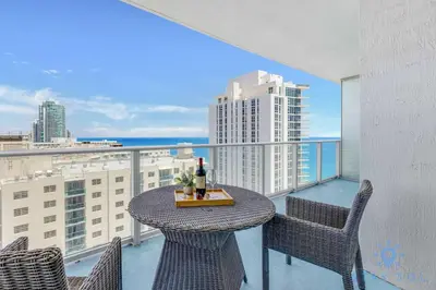a table and chairs on a balcony with a view at 2 BR Apartment with Amenities and Balcony in Hollywood