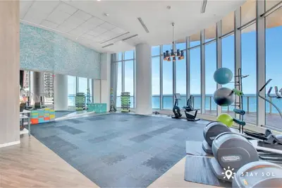 a gym with a view of the ocean at 2 BR Apartment with Amenities and Balcony in Hollywood