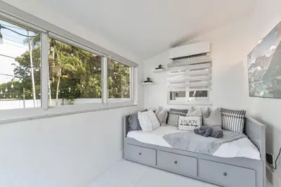 a white bedroom with a bed and windows at Casa Belle 3br W Pool & Bbq 10 Mins To Beach in Miami