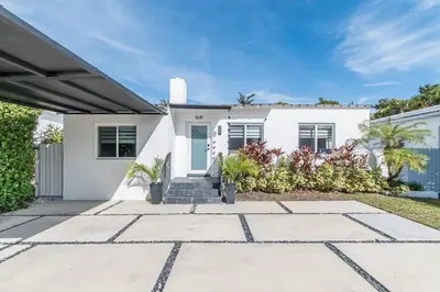 a white house with plants in front of it at Casa Belle 3br W Pool & Bbq 10 Mins To Beach in Miami