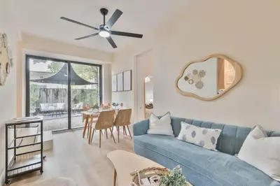 a living room with a blue couch and a table at Casa Bellini Modern 3br W Bbq -10 Mins To Beac in Miami