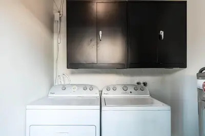 a kitchen with a stove and a cabinet at Casa Bellini Modern 3br W Bbq -10 Mins To Beac in Miami