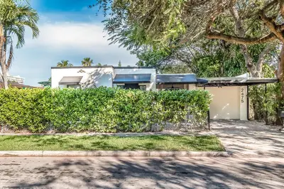 a house with a hedge in front of a building at Casa Bellini Modern 3br W Bbq -10 Mins To Beac in Miami