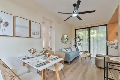 a living room with a ceiling fan and a dining room at Casa Bellini Modern 3br W Bbq -10 Mins To Beac in Miami