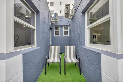 two chairs sitting on a table next to a building at Banyan St. 1BR 1BA off Las Olas - Steps to Beach in Fort Lauderdale
