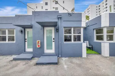 a blue house with a white door at Banyan St. 1BR 1BA off Las Olas - Steps to Beach in Fort Lauderdale