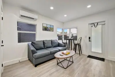 a living room with a couch and a table at Banyan St. 1BR 1BA off Las Olas - Steps to Beach in Fort Lauderdale