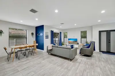 a living room with a couch and a table and chairs at 3BR 2.5BA Townhome-10 mins to FTL Beach and Downtown in Fort Lauderdale