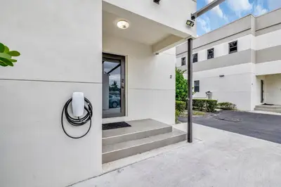 a white house with a sigil on the side of it at 3BR 2.5BA Townhome-10 mins to FTL Beach and Downtown in Fort Lauderdale