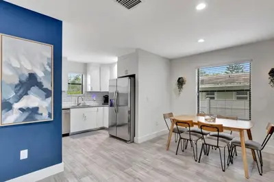 a kitchen and dining room with a table and chairs at 3BR 2.5BA Townhome-10 mins to FTL Beach and Downtown in Fort Lauderdale