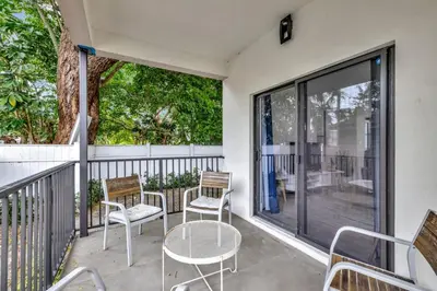 a patio with chairs and a table on a balcony at 3BR 2.5BA Townhome-10 mins to FTL Beach and Downtown in Fort Lauderdale