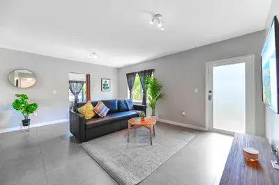 a living room with a couch and a table at Comfy & Spacious Duplex w Top Amenities! in Miami