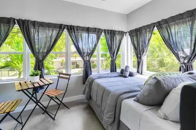 a bedroom with two beds and a window at Comfy & Spacious Duplex w Top Amenities! in Miami