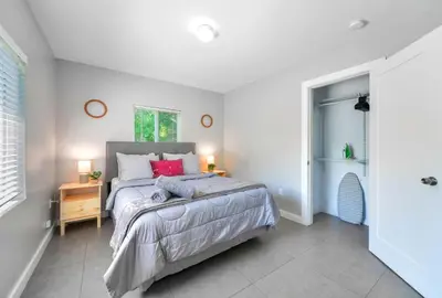 a bedroom with a large bed and a window at Comfy & Spacious Duplex w Top Amenities! in Miami