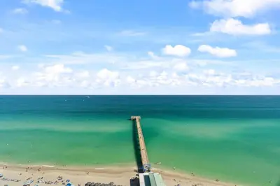 an aerial view of a beach with the ocean at Luxurious 2BD Condo with Direct Ocean Front & Resort Pool in Sunny Isles in Sunny Isles Beach