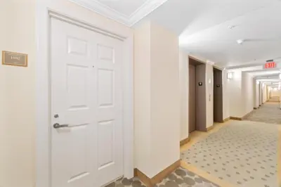 a corridor with a white door in a hallway at Luxurious 2BD Condo with Direct Ocean Front & Resort Pool in Sunny Isles in Sunny Isles Beach