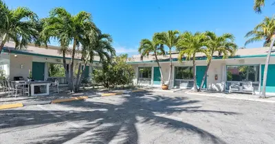 a building with palm trees in front of it at Beachside Studio in Hollywood