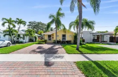 a house with palm trees and a driveway at 1644 Jackson St, Hollywood, FL 33020 in Hollywood
