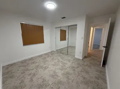 an empty room with white walls and tile floors at 1644 Jackson St, Hollywood, FL 33020 in Hollywood