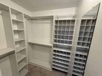a walk in closet with white shelving at 1644 Jackson St, Hollywood, FL 33020 in Hollywood